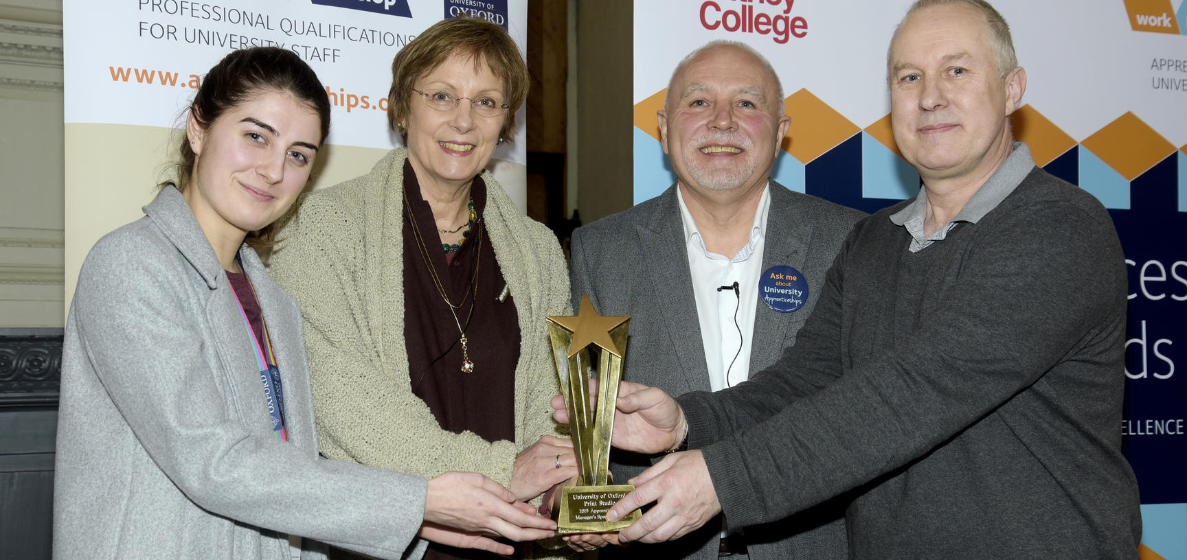 Manager Bob Malloy, and apprentice Jordan Morris from the print studio accepting their award from Clive Shepherd and the registrar Gill Aitken at the 2019 University Apprenticeship awards