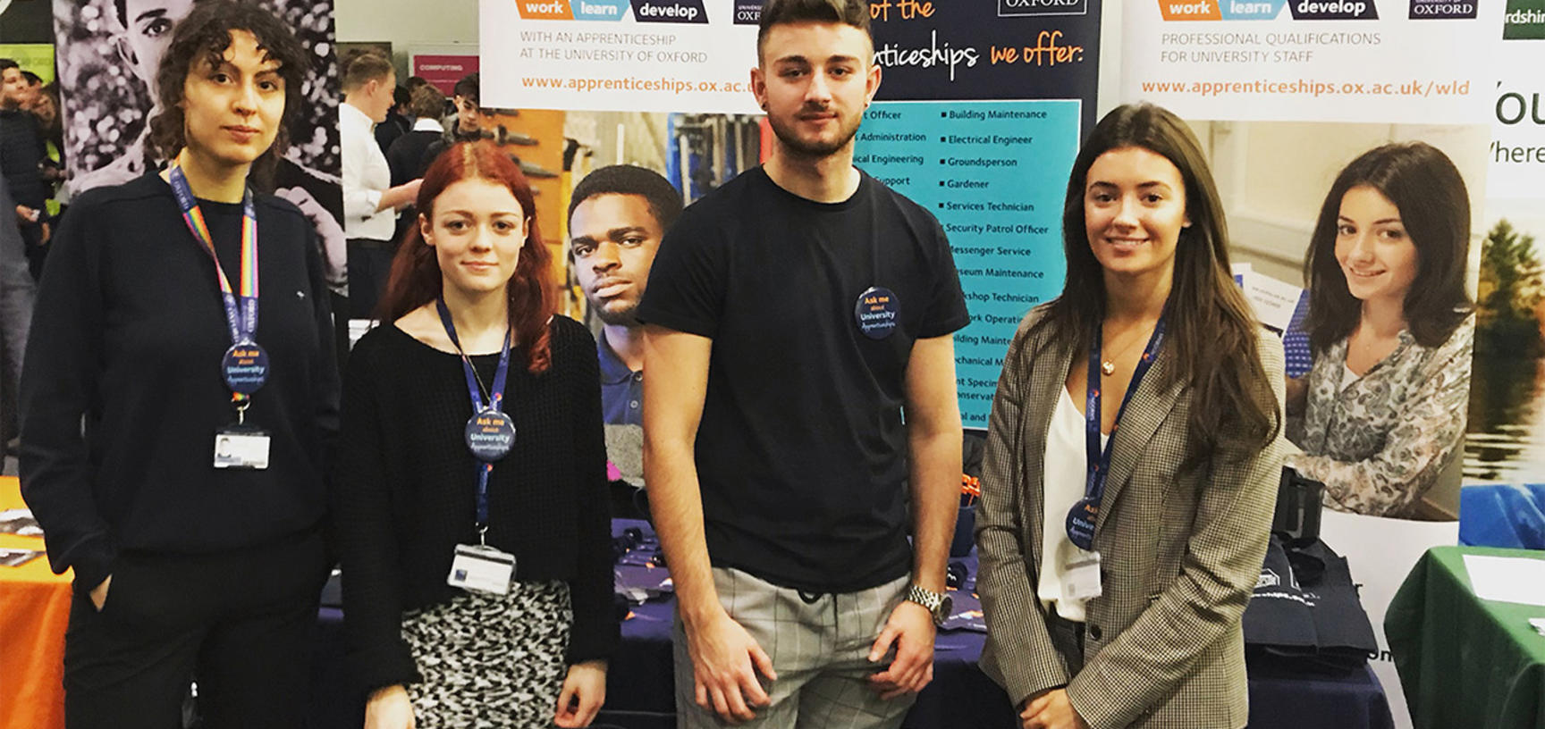 Four University apprentices next to our University Apprenticeships stand at the 2019 Career fest at BMW