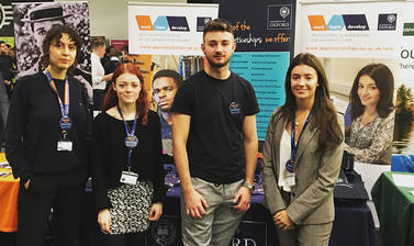 Four University apprentices next to our University Apprenticeships stand at the 2019 Career fest at BMW